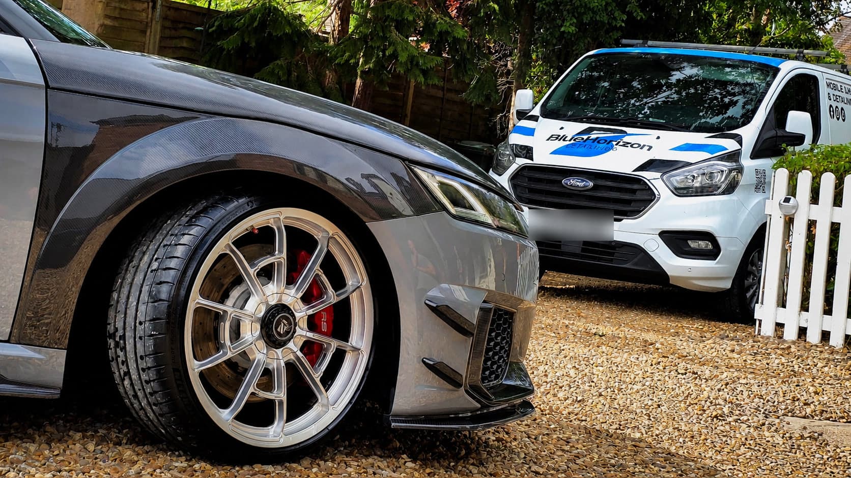 Audi TT RS forged wheel and carbon front wing cleaned on the owner's driveway, with the Blue Horizon Detailing van alongside — mobile valeting Warwickshire