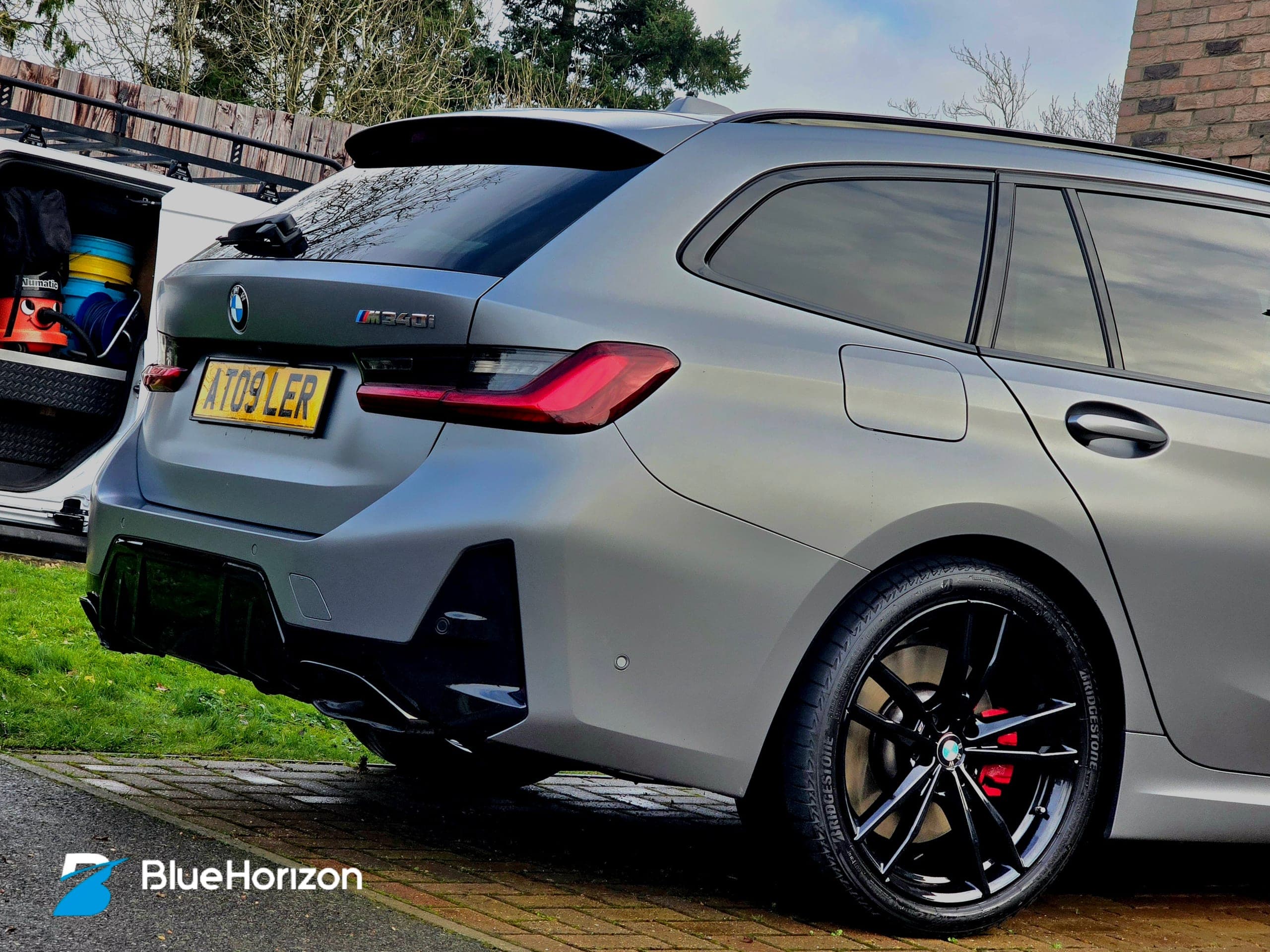 BMW M340i Touring rear quarter showing M340i badge and immaculate matte grey finish after specialist care
