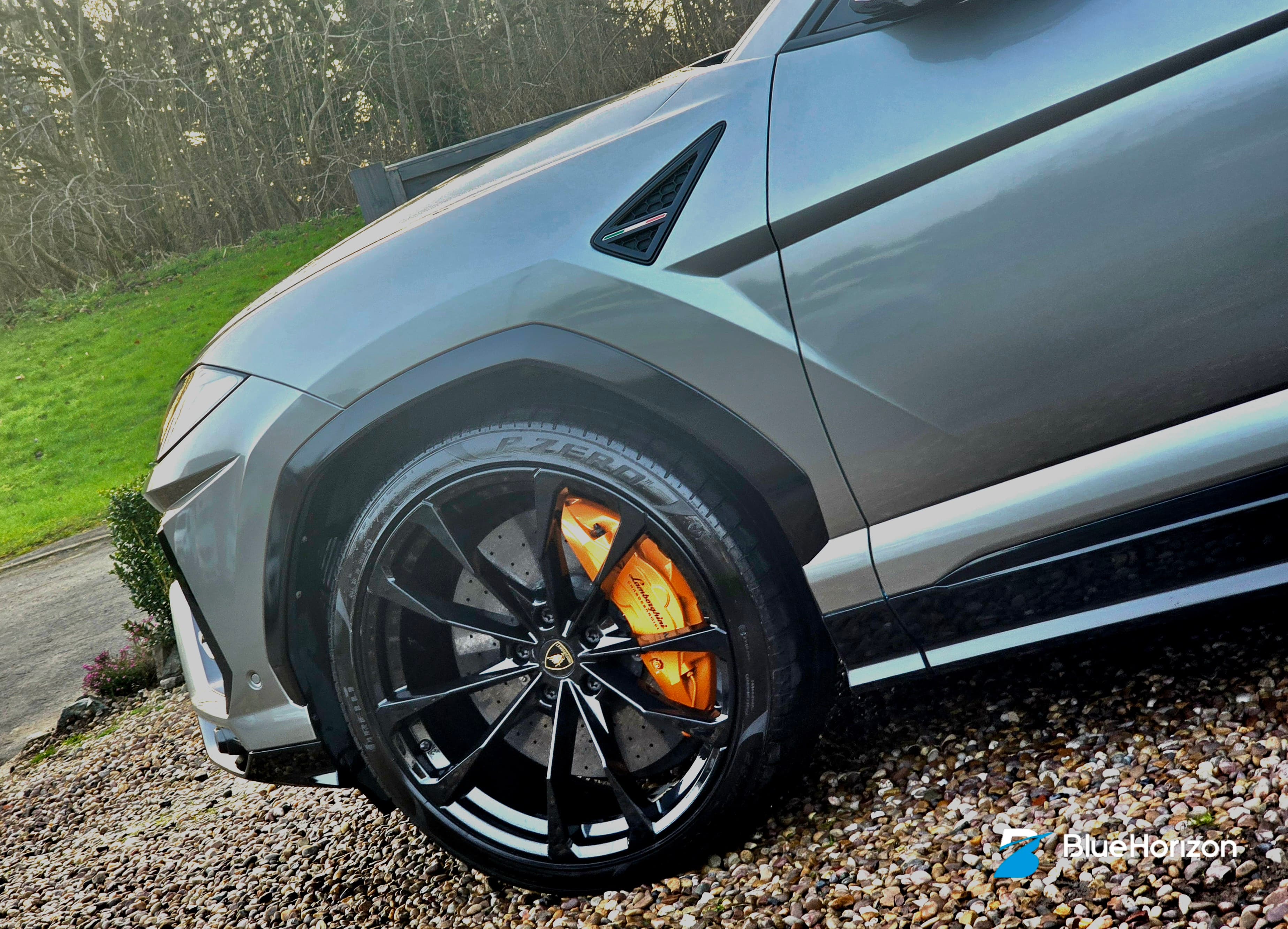 Lamborghini Urus front wheel showing painted orange brake caliper — caliper painting service Warwickshire by Blue Horizon Detailing