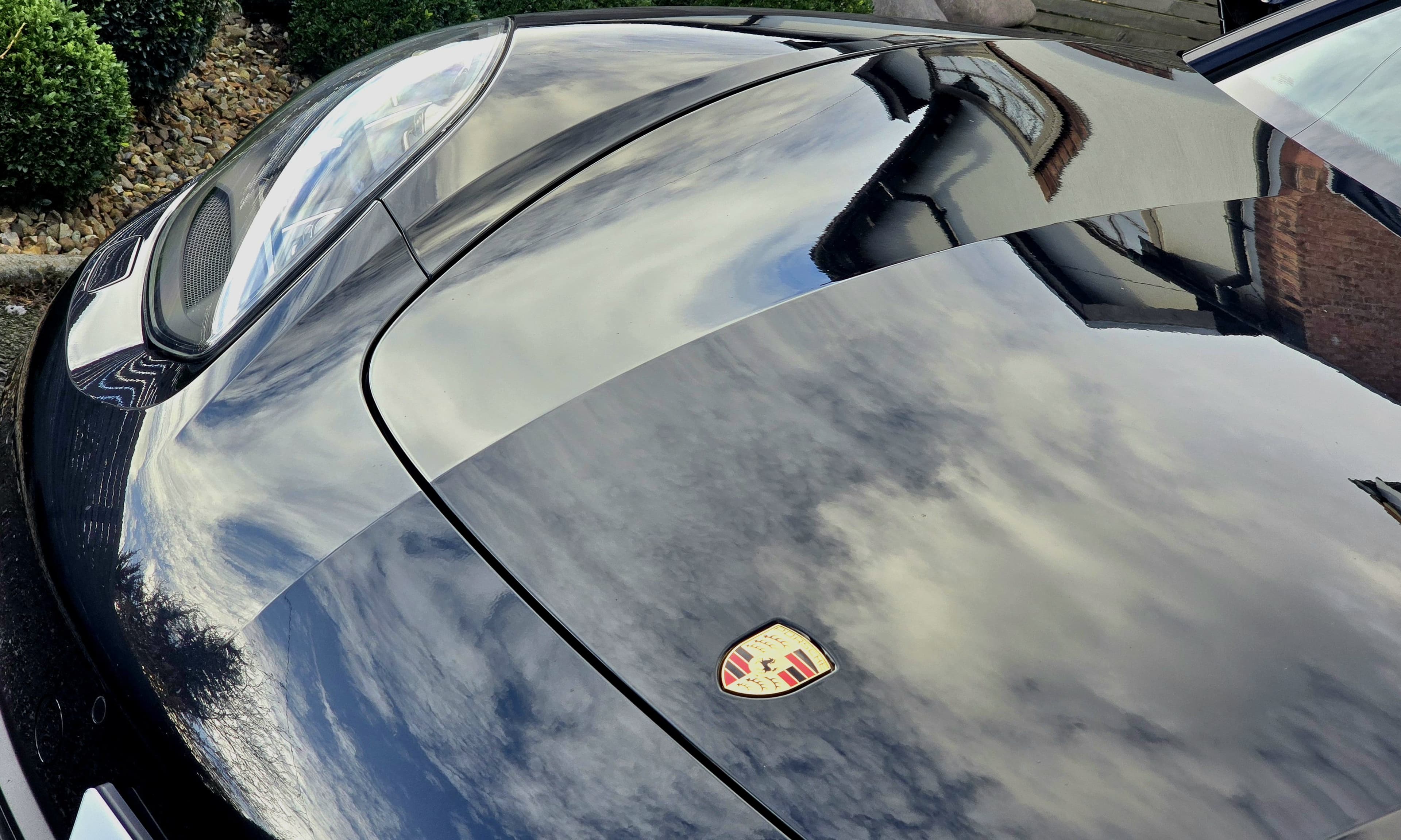 Perfect sky reflection in dark Porsche bonnet — glass-like show-car paint finish after Flawless Finish Package by Blue Horizon Detailing, Warwickshire